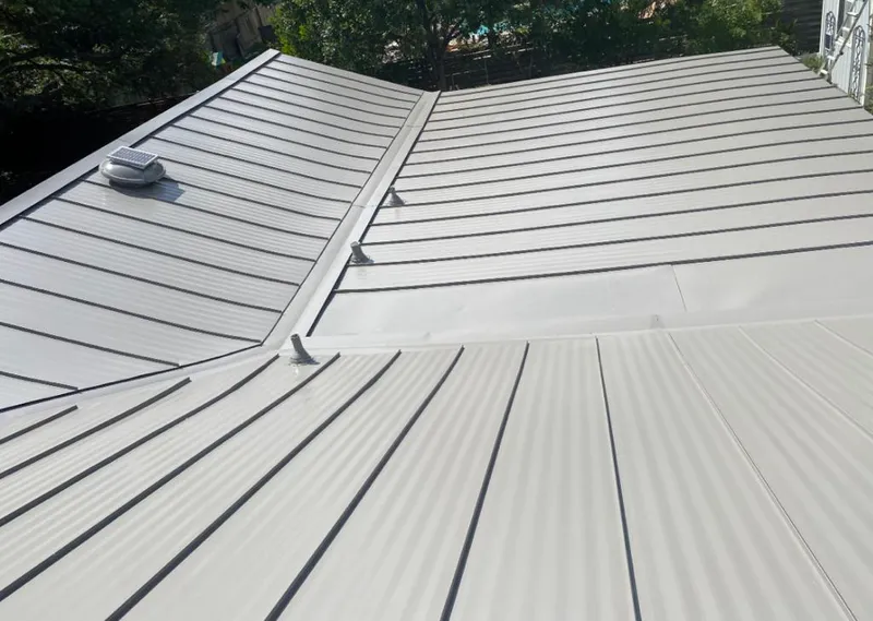 Solar attic fan installed on a metal roof for Roof Ventilation in Lake Holiday