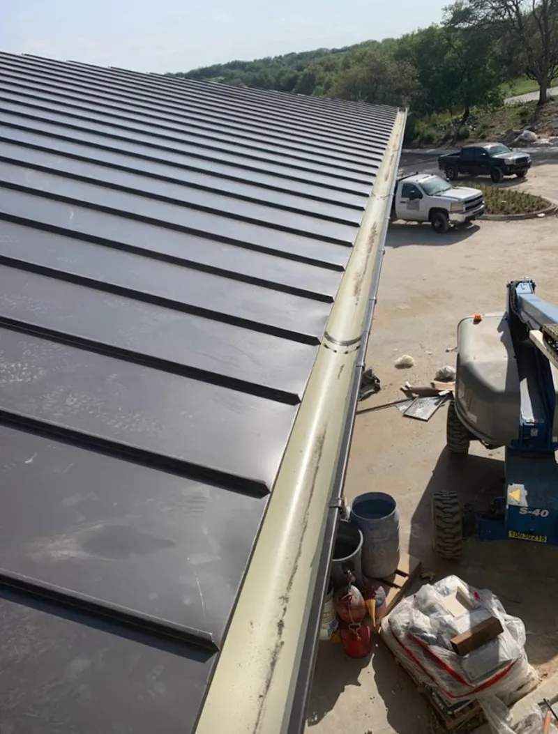 Standing seam panel and gutter detail on a metal roofing jobsite in Lake Holiday